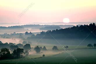 Sunset over misty landscape
