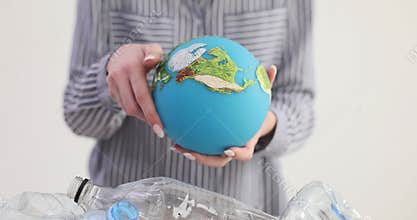 Recycling plastic bottles at a recycling plant and a globe