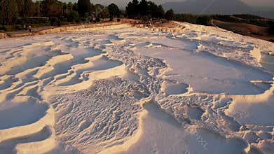 Aerial view of the travertines in Pamukkale in a beautiful sunset, Turkey. White limestone mineral formations. Turkish