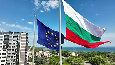 Close-up view of the European Union and Bulgaria flags waving in the wind against city Varna