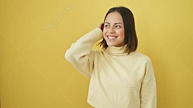 Laughing young hispanic woman in yellow, natural expression, confident smile and beautiful side profile