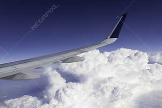 Winglet of a Jet Airliner Wing Flying Above the Clouds