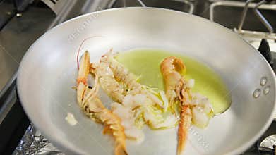 Adding Swordfish Into A Kitchen Pan With Fresh Prawns
