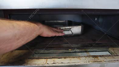Cook Is Baking Swordfish Rolls In Restaurant Kitchen