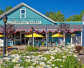 historic grocery store and market with outdoor seating with Summer daisy flowers