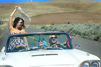 Happy Party Girls in Convertible