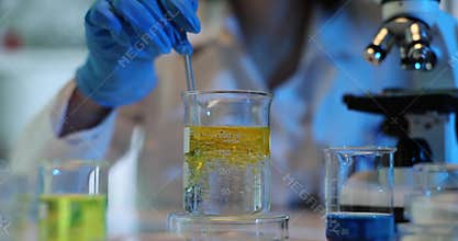 Chemical laboratory experiment. Measuring density of liquid oil and water
