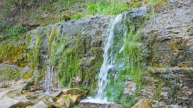 Brooks flowing down rocky slope. Slavonic springs, Izborsk.