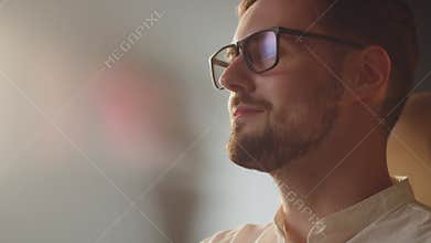 Caucasian programmer guy in glasses coding his first program. Finally done programming code. Satisfied freelancer man