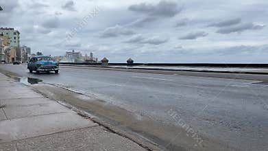 old retro style auto driving by beach embankment road, travel destination Cuba Havana amateur video