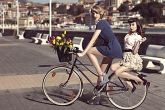 Two vintage women on bicycle near the sea