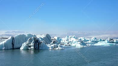 Jokulsarlon Glacier Lagoon with Blue Icebergs and Snow-Capped Mountains