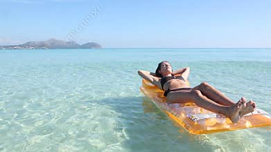 Young woman on pool raft