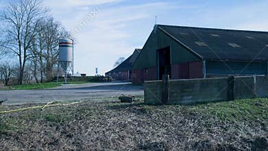 Rural farm buildings and a silo in the countryside