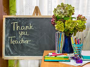 Teacher Day. Hydrangea flowers and copybooks on the teacher's d