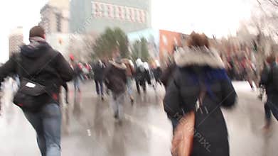 Group of riot police officers run and disperse demonstrators