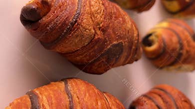Chocolate croissants arranged neatly tracking shot