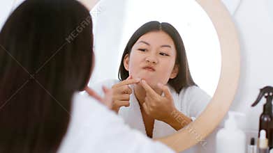 Young woman performs skincare routine at home to achieve clear skin