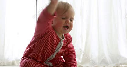 Angry cute baby crying and crawling away