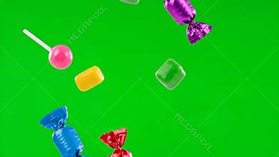 Blue and Red Candies Floating Against Green Screen Background