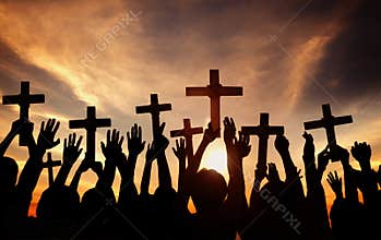 Group of People Holding Cross and Praying in Back Lit