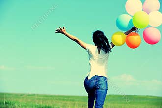 Young asian woman with colored balloons