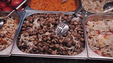 Marinated mushrooms displayed at store counter.