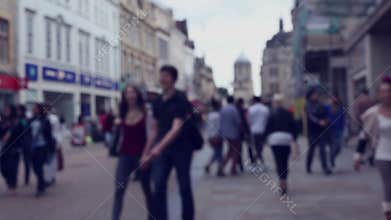 Blurred street scene with crowds of shoppers