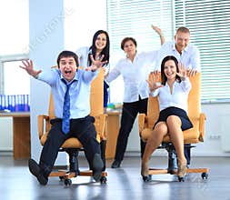 Happy office employees having fun at work