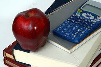 Apple, books, and calculator close-up