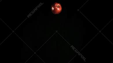 Red apple falling in super slow motion