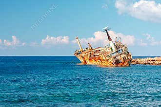 The Edro III, Pegeia, Cyprus - rusty shipwreck resting along a quiet breakwater under a bright blue sky