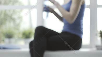 Woman having a break after working out at home