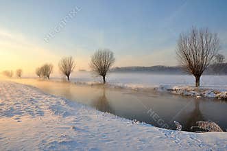 Dutch winter landscape with snow and low sun