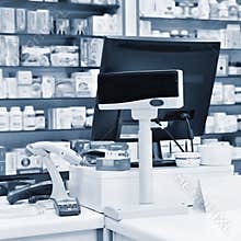 Cash desk - computer and monitor in a pharmacy. Interior of drug and vitamins shop. Concept for medicine and health - Coronavirus