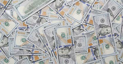 Lot of cash hundred dollar bond falling down