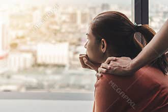 PTSD Mental health concept, Psychologist sitting and touch young depressed asian woman for encouragement near window with low