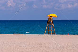 Bored lifeguard alone on the beach, no vacationers