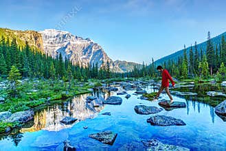 Boy Wearing Face Mask Rock Hopping on Lake in Staycation to Park