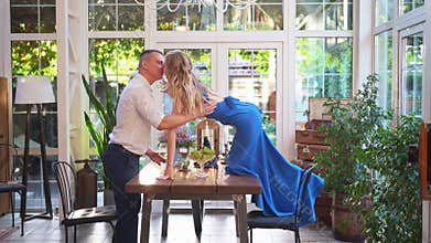 Romantic dinner for couple. girl with glass stands on table to kiss boyfriend.