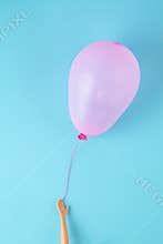 Doll hand holding colorful balloons. Party, celebration, childhood