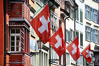 Old street in Zurich decorated with flags