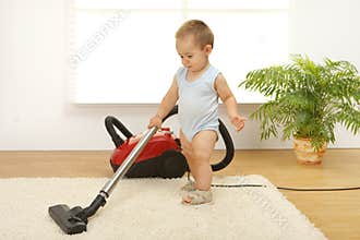Baby boy with vacuum cleaner