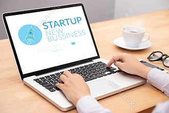 Business people working on notebook laptop computer with startup business and rocket logo on screen, start up ideas business