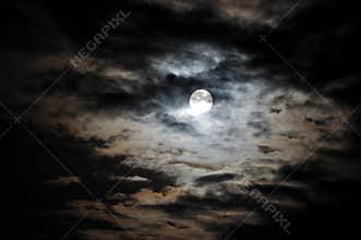 Full moon and white clouds on black night sky
