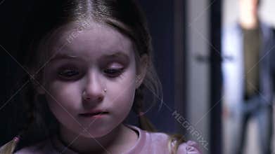 Adorable upset orphan girl crying, man appearing in door to adopt child, custody