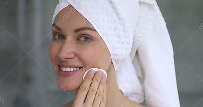 Healthy happy beautiful lady cleaning facial skin care holding sponge