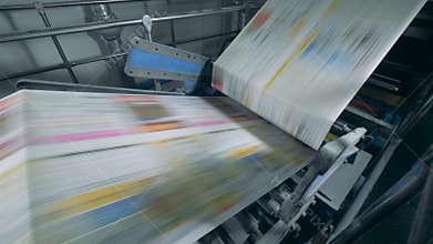 Printing press with uncut magazine pages going through it