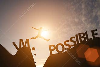 Man jump between impossible wording and possible wording on mountain. Mindset for career growth business