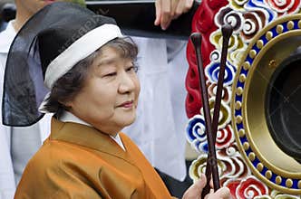 Woman playing the drum at the Takayama festival, Japan